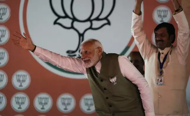 Indian Prime Minister Narendra Modi waves towards the crowd as he arrives to address the election rally in Srinagar, Indian controlled Kashmir, Thursday, Sept. 19, 2024. (AP Photo/Mukhtar Khan)