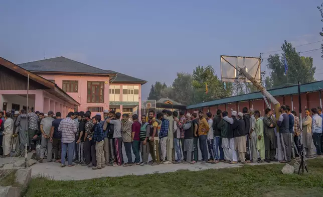 Kashmiri's queue up at a polling booth to cast their vote during the second phase of the assembly election in the outskirts of Srinagar, Indian controlled Kashmir, Wednesday, Sept. 25, 2024. (AP Photo/Dar Yasin)