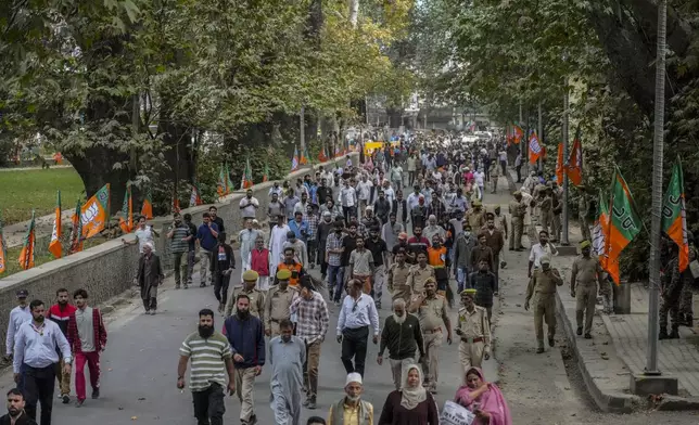 Policemen and supporters of Indian Prime Minister Narendra Modi leave the venue after an election rally in Srinagar, Indian controlled Kashmir, Thursday, Sept. 19, 2024. (AP Photo/Mukhtar Khan)