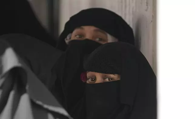 Muslim women voter queue up to cast their vote at a polling booth during the first phase of the Jammu and Kashmir assembly election, in Kishtwar, India, Wednesday, Sept. 18, 2024. (AP Photo/Channi Anand)