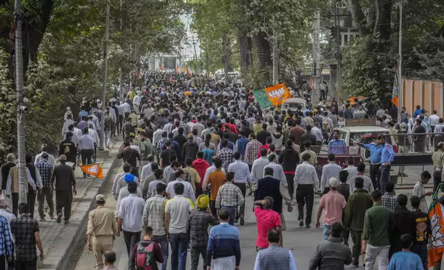 Policemen and supporters of Indian Prime Minister Narendra Modi leave the venue after an election rally in Srinagar, Indian controlled Kashmir, Thursday, Sept. 19, 2024. (AP Photo/Mukhtar Khan)