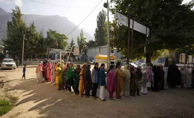 People queue up to cast their vote at a polling booth during the first phase of the Jammu and Kashmir Assembly election, in Kishtwar, India, Wednesday, Sept. 18, 2024. (AP Photo/Channi Anand)