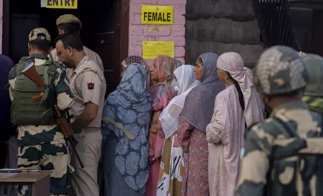 Kashmiri women queue up at a polling booth to cast their vote during the second phase of the assembly election in the outskirts of Srinagar, Indian controlled Kashmir, Wednesday, Sept. 25, 2024. (AP Photo/Dar Yasin)