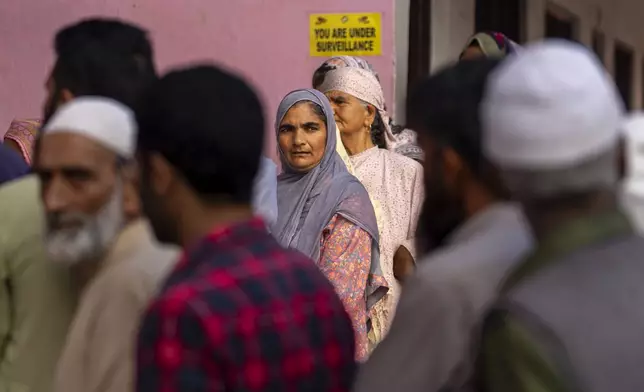 Kashmiri's queue up at a polling booth to cast their vote during the second phase of the assembly election in the outskirts of Srinagar, Indian controlled Kashmir, Wednesday, Sept. 25, 2024. (AP Photo/Dar Yasin)