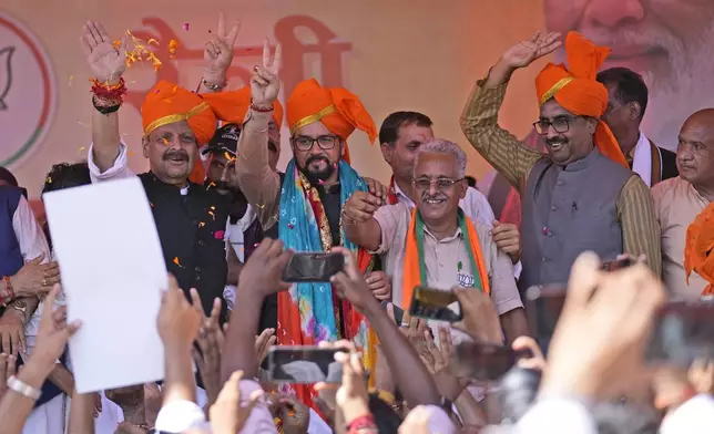 Former union minster and star campaigner of BJP Anurag Thakur and state in charge Ram Madhav wave to supporters during a campaign rally, after party candidates filed the nomination papers for the upcoming Jammu and Kashmir Assembly elections at Nagrota outskirts of Jammu, India, Thursday, Sep.12, 2024.(AP Photo/Channi Anand, File)