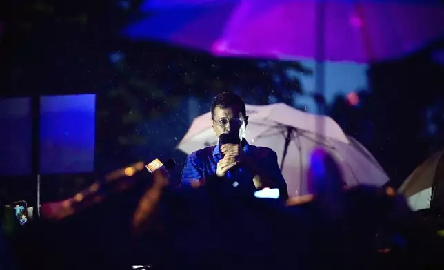 Aam Aadmi Party leader and Chief Minister of Delhi, Arvind Kejriwal, speaks to his followers in the rain as he comes out of Tihar prison after being granted bail by the country's highest court, in New Delhi, India, Friday, Sept. 13, 2024. (AP Photo/Manish Swarup)