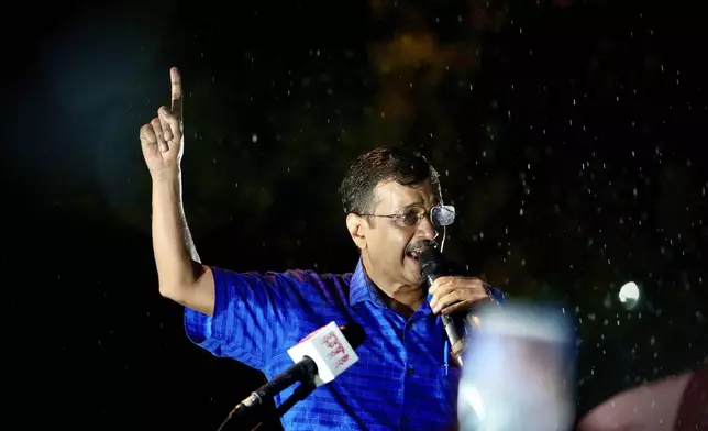 Aam Aadmi Party leader and Chief Minister of Delhi, Arvind Kejriwal, speaks to his followers in the rain as he comes out of Tihar prison after being granted bail by the country's highest court, in New Delhi, India, Friday, Sept. 13, 2024. (AP Photo/Manish Swarup)