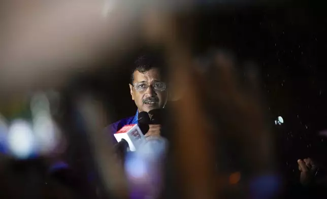 Aam Aadmi Party leader and Chief Minister of Delhi, Arvind Kejriwal, speaks to his followers in the rain as he comes out of Tihar prison after being granted bail by the country's highest court, in New Delhi, India, Friday, Sept. 13, 2024. (AP Photo/Manish Swarup)