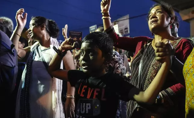 People demand justice for the rape and murder of a resident doctor at a government hospital in early August, during a torch light protest rally in Kolkata, India, Friday, Sept. 20, 2024. (AP Photo/Bikas Das)