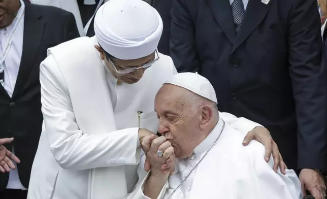 Pope Francis, right, kisses the right hand of the Grand Imam of Istiqlal Mosque Nasaruddin Umar after an interreligious meeting with religious leaders at the Istiqlal Mosque in Jakarta, Thursday, Sept. 5, 2024. (Aditya Aji /Pool Photo via AP)