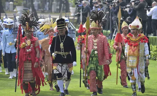 Participants in traditional attire and uniformed personnel stand in formation ahead of the ceremonial welcome for Pope Francis at the Presidential Palace in Jakarta Wednesday, Sept. 4, 2024. (Bay Ismoyo/Pool Photo via AP)