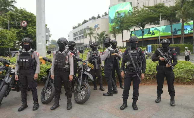 Indonesian police officers stand guard on the street in Jakarta, Indonesia, Tuesday, Sept. 3, 2024. (AP Photo/Tatan Syuflana)