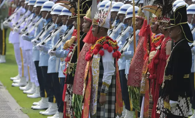 Participants in traditional attire and uniformed personnel stand in formation ahead of the ceremonial welcome for Pope Francis at the Presidential Palace in Jakarta Wednesday, Sept. 4, 2024. (Bay Ismoyo/Pool Photo via AP)