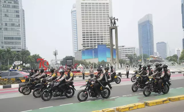 Police on motorcycles patrol on the street in Jakarta, Indonesia, Tuesday, Sept. 3, 2024. (AP Photo/Tatan Syuflana)