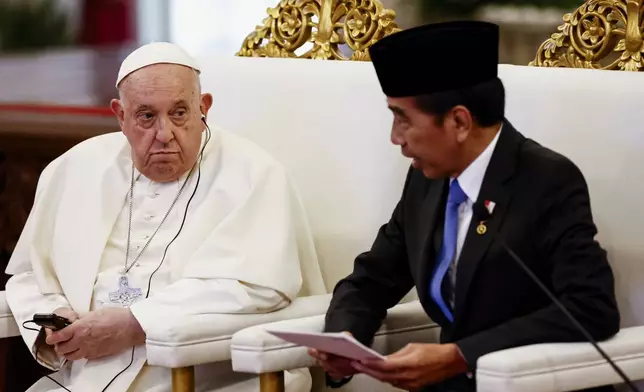 Pope Francis, left, and Indonesian President Joko Widodo attend a meeting with Indonesian authorities, civil society and the diplomatic corps, during his apostolic visit to Asia, at the Presidential Palace in Jakarta Wednesday, Sept. 4, 2024. (Willy Kurniawan/Pool Photo via AP)