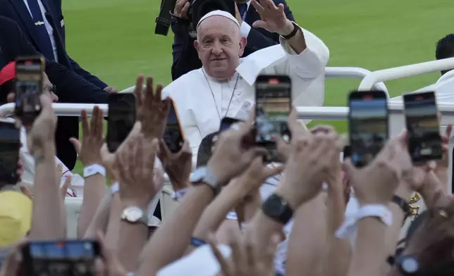 Pope Francis arrives to lead the holy mass at Gelora Bung Karno Stadium in Jakarta, Indonesia, Thursday, Sept. 5, 2024. (AP Photo/Achmad Ibrahim, Pool)