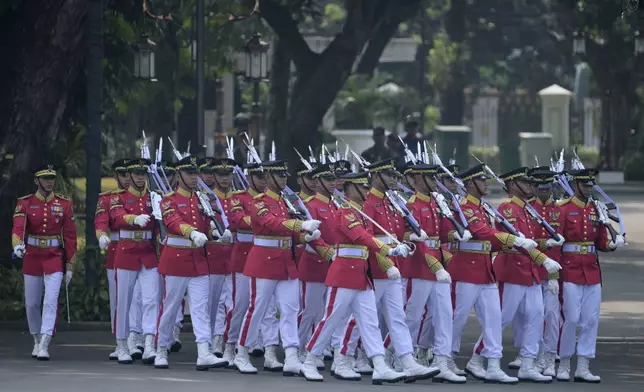 Members of an honour guard march to positions ahead of the ceremonial welcome for Pope Francis at the Presidential Palace in Jakarta Wednesday, Sept. 4, 2024. (Bay Ismoyo/Pool Photo via AP)