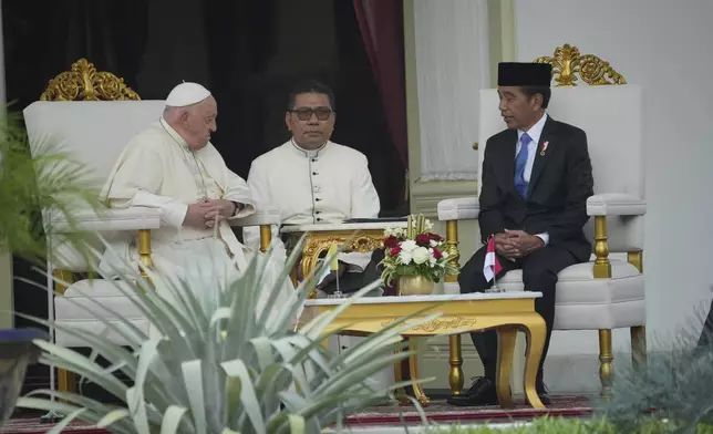 Pope Francis, left, talks with Indonesian President Joko Widodo, right, at the Presidential Palace in Jakarta, Indonesia, Wednesday, Sept. 4, 2024. (AP Photo/Achmad Ibrahim, Pool)