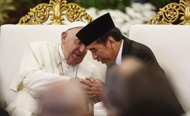 Pope Francis, left, and Indonesian President Joko Widodo attend a meeting with Indonesian authorities, civil society and the diplomatic corps, during his apostolic visit to Asia, at the Presidential Palace in Jakarta Wednesday, Sept. 4, 2024. (Willy Kurniawan/Pool Photo via AP)