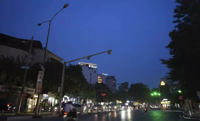 FILE- Road lights are switched off to save energy in Hanoi, on June 8, 2023. (AP Photo/Hau Dinh, File)