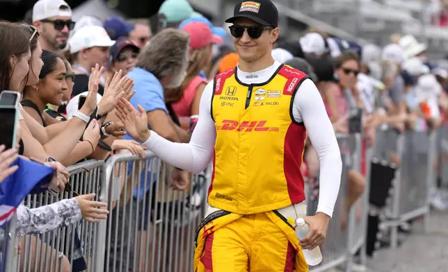 Driver Alex Palou, right, greets fans before an IndyCar auto race Sunday, Sept. 15, 2024, at Nashville Superspeedway in Lebanon, Tenn. (AP Photo/Mark Humphrey)