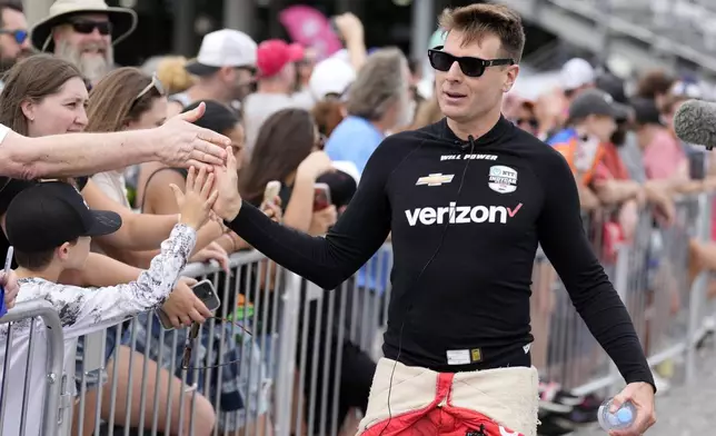 Driver Will Power, right, greets fans before an IndyCar auto race Sunday, Sept. 15, 2024, at Nashville Superspeedway in Lebanon, Tenn. (AP Photo/Mark Humphrey)