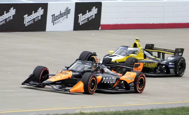 Pato O'Ward (5) and Colton Herta (26) drive during an IndyCar auto race Sunday, Sept. 15, 2024, at Nashville Superspeedway in Lebanon, Tenn. (AP Photo/Mark Humphrey)