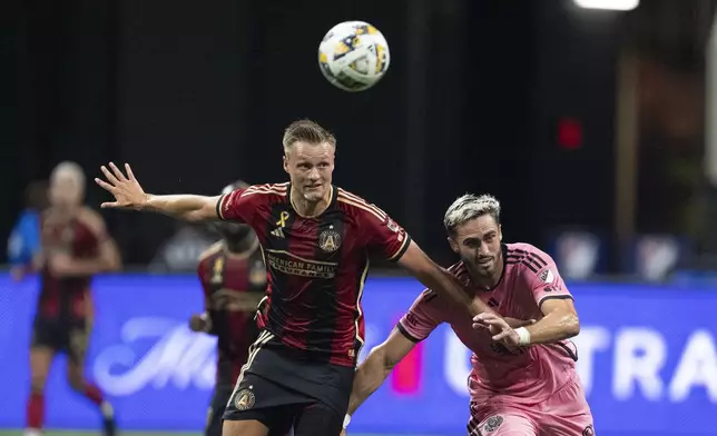 Atlanta United defender Stian Gregersen (5) and Inter Miami forward Leonardo Campana (8) battle for the ball during thre first half of a MLS soccer match Wednesday, Sept. 18, 2024. (AP Photo/John Bazemore)