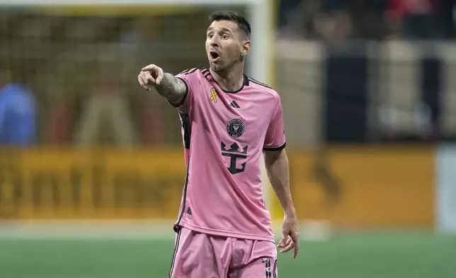 Inter Miami forward Lionel Messi talks to a teammate during the second half of a MLS soccer match against Atlanta United Wednesday, Sept. 18, 2024. (AP Photo/John Bazemore)