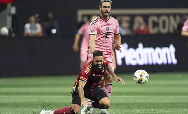 Atlanta United defender Derrick Williams (3) and Inter Miami forward Leonardo Campana (8) chase the ball during thre first half of a MLS soccer match Wednesday, Sept. 18, 2024. (AP Photo/John Bazemore)