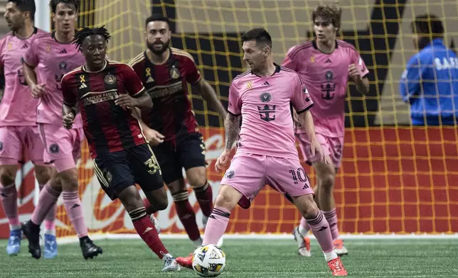 Inter Miami forward Lionel Messi (10) works in front of Atlanta United midfielder Ajani Fortune (35) during the second half of a MLS soccer match Wednesday, Sept. 18, 2024. (AP Photo/John Bazemore)