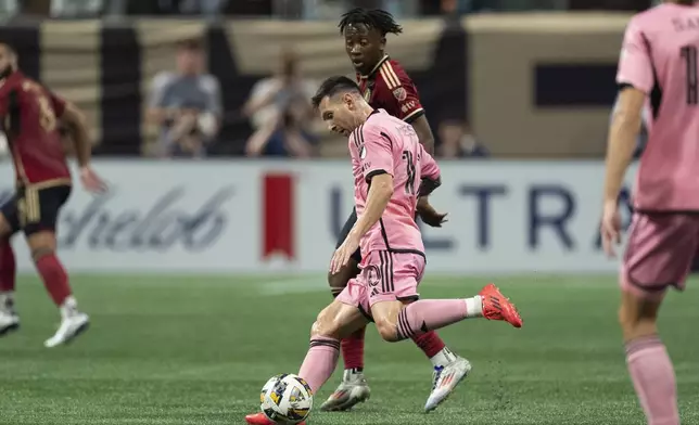 Inter Miami forward Lionel Messi (10) works in front of Atlanta United midfielder Ajani Fortune (35) during the second half of a MLS soccer match Wednesday, Sept. 18, 2024. (AP Photo/John Bazemore)