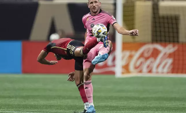 Inter Miami defender Serhiy Kryvtsov (27) and Atlanta United forward Daniel Ríos (19) battle for the ball during thre first half of a MLS soccer match Wednesday, Sept. 18, 2024. (AP Photo/John Bazemore)