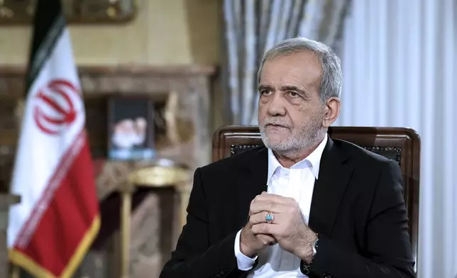 In this photo released by the Iranian Presidency Office, President Masoud Pezeshkian speaks in a live televised interview by state TV, at his office in Tehran, Iran, Saturday, Aug. 31, 2024. (Iranian Presidency Office via AP)