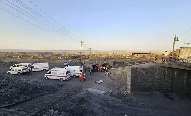 In this photo released by Iranian Red Crescent Society, ambulances stand at the site of a coal mine where methane leak sparked an explosion on Saturday, in Tabas, some 335 miles (540 kilometers) southeast of the capital Tehran, Iran, Sunday, Sept. 22, 2024. (Iranian Red Crescent Society, via AP)