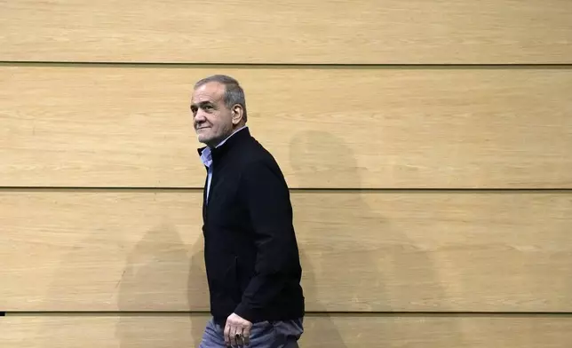 Iranian President Masoud Pezeshkian walks towards the podium at his press conference in Tehran, Iran, Monday, Sept. 16, 2024. (AP Photo/Vahid Salemi)