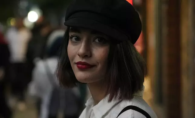 FILE - An Iranian woman without wearing her mandatory Islamic headscarf walks in downtown Tehran, Iran, June 10, 2024. (AP Photo/Vahid Salemi, File)