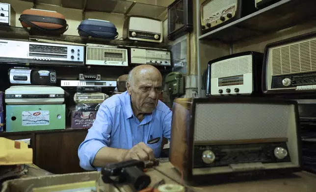 Reza Alimirzaei, 73, who repairs and sells old radios, works at his shop in downtown Tehran, Iran, Wednesday, Sept. 18, 2024. (AP Photo/Vahid Salemi)