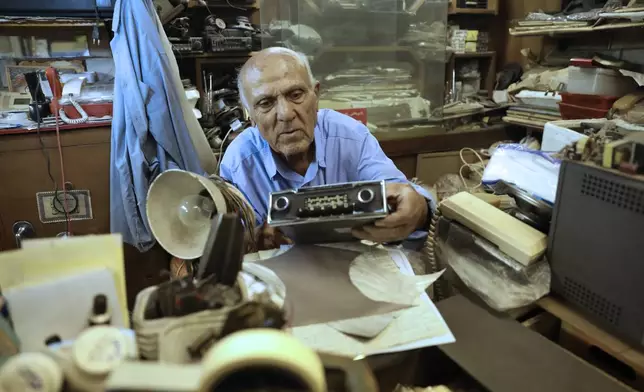 Reza Alimirzaei, 73, who repairs and sells old radios, works at his shop in downtown Tehran, Iran, Wednesday, Sept. 18, 2024. (AP Photo/Vahid Salemi)
