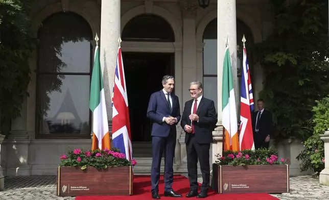 The Prime Minister of Ireland Simon Harris, left, gestures as he greets his British counterpart Keir Starmer as they meet for talks at Farmleigh House in Dublin, Ireland, Saturday, Sept. 7, 2024. (AP Photo/Peter Morrison Pool)