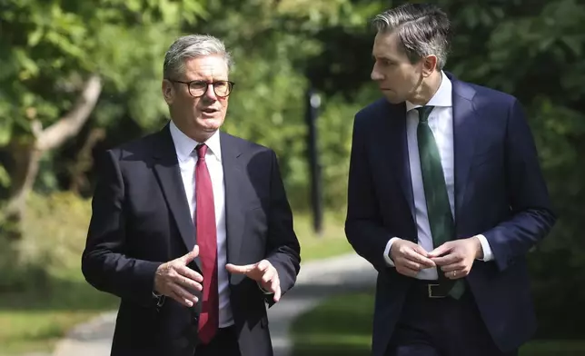 The Prime Minister of Ireland Simon Harris, right, listens to his British counterpart Keir Starmer as they meet for talks at Farmleigh House in Dublin, Ireland, Saturday, Sept. 7, 2024. (AP Photo/Peter Morrison Pool)