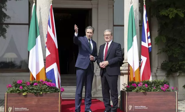 The Prime Minister of Ireland Simon Harris, left, gestures as he greets his British counterpart Keir Starmer as they meet for talks at Farmleigh House in Dublin, Ireland, Saturday, Sept. 7, 2024. (AP Photo/Peter Morrison Pool)