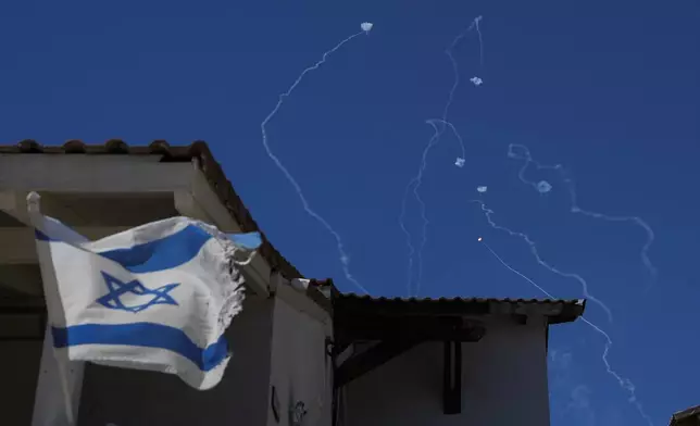 The Israeli Iron Dome air defense system fires to intercept rockets that were launched from Lebanon, as seen from Safed, northern Israel, on Saturday, Sept. 28, 2024. (AP Photo/Baz Ratner)