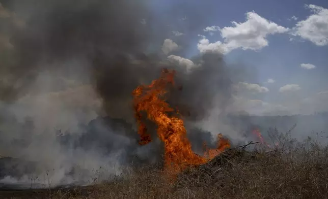 A fire burns in an area, following an attack from Lebanon, near the Kibbutz Snir, northern Israel, Monday, Sept. 16, 2024. (AP Photo/Leo Correa)