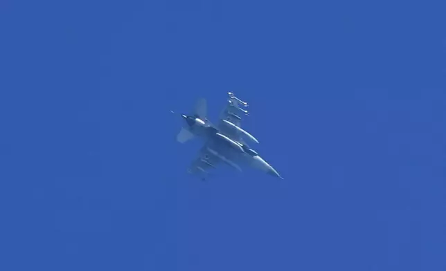 An armed Israeli fighter jet is seen from Haifa, northern Israel, on Monday, Sept. 23, 2024. (AP Photo/Baz Ratner)