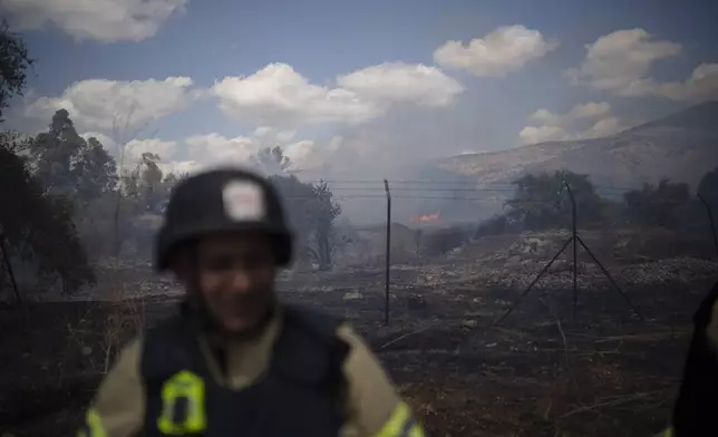 An Israeli firefighter works to extinguish a fire burning in an area, following an attack from Lebanon, near the Kibbutz Snir, northern Israel, Monday, Sept. 16, 2024. (AP Photo/Leo Correa)