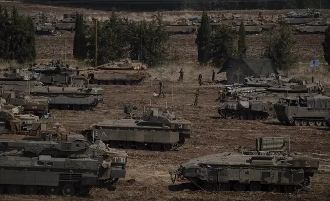 Israeli soldiers work on tanks and armoured personnel carriers (APC) in northern Israel, Monday, Sept. 30, 2024. (AP Photo/Leo Correa)