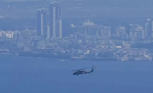 An Israeli Air Force Black Hawk helicopter flies over the Mediterranean Sea near the northern Israeli city of Kiryat Yam, Thursday, Sept. 26, 2024. (AP Photo/Baz Ratner)