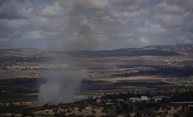 Smoke rises to the sky as fire burns in an area, following an attack from Lebanon, near the Kibbutz Snir, as seen from the Israeli-annexed Golan Heights, Monday, Sept. 16, 2024. (AP Photo/Leo Correa)