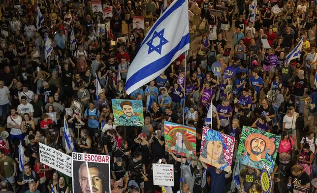 People protest against Prime Minister Benjamin Netanyahu's government and call for the release of hostages held in the Gaza Strip by the Hamas militant group, in Tel Aviv, Israel, Saturday, Aug. 31, 2024. (AP Photo/Ohad Zwigenberg)